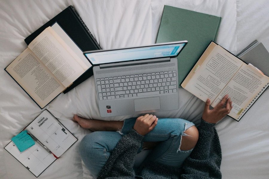 Empower your academic journey with effective Study Resolutions: A student immersed in focused study with a laptop and book. 